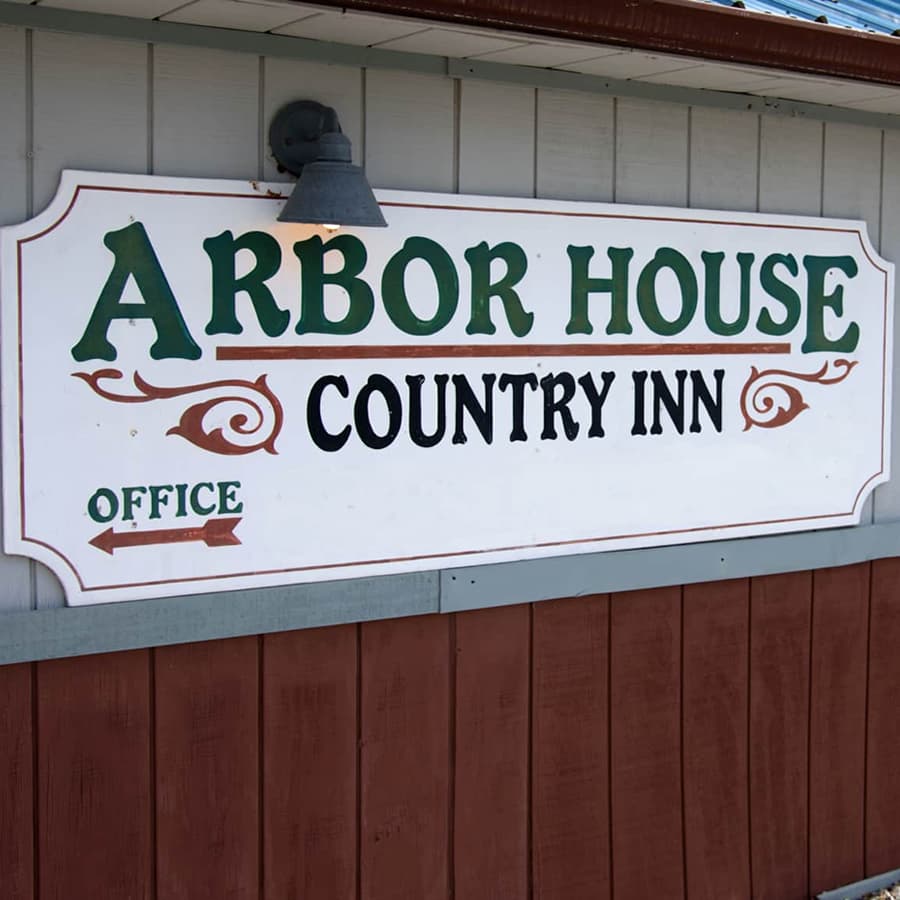 Wood painted sign for Arbor house Inn on building