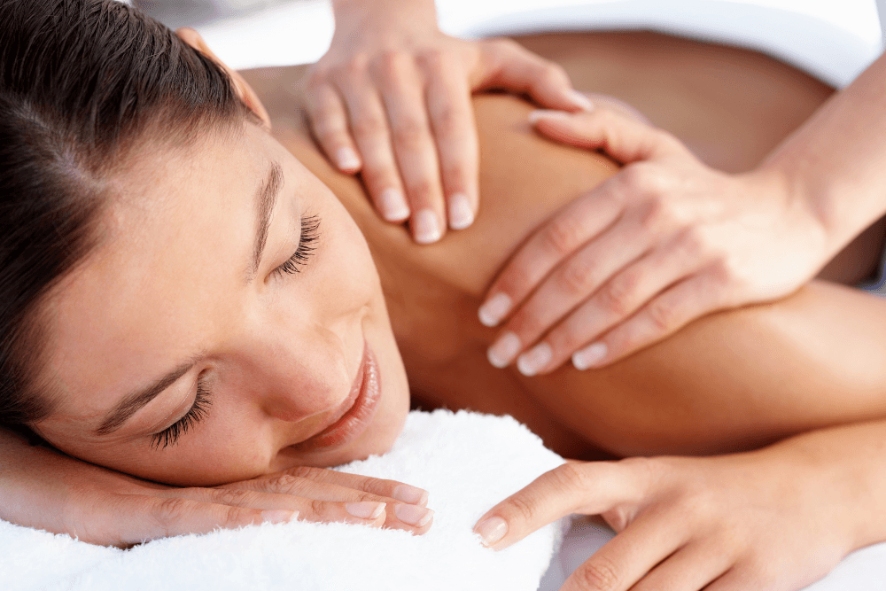 Woman lying on stomach receiving a massage